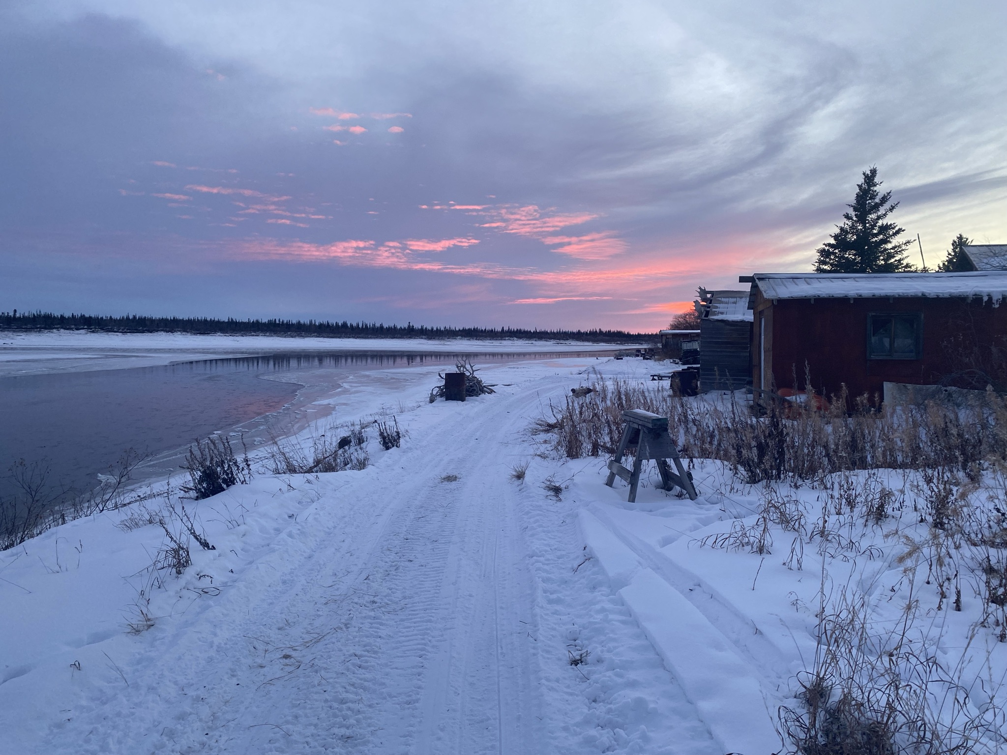 Trusts and Settlements - Snowy road next to river and cabins