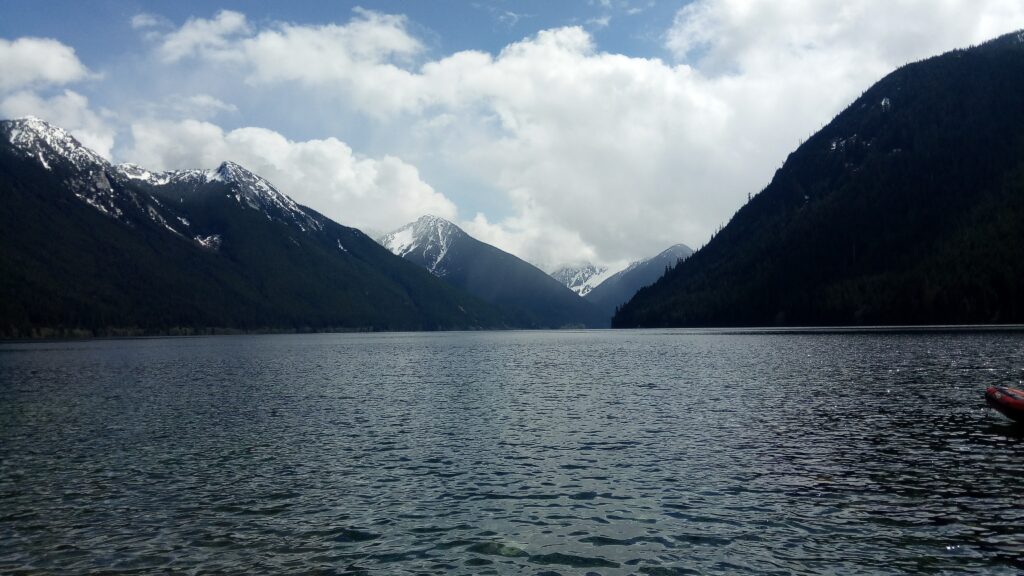 Tall snow-capped mountains along large river (Harrison River)