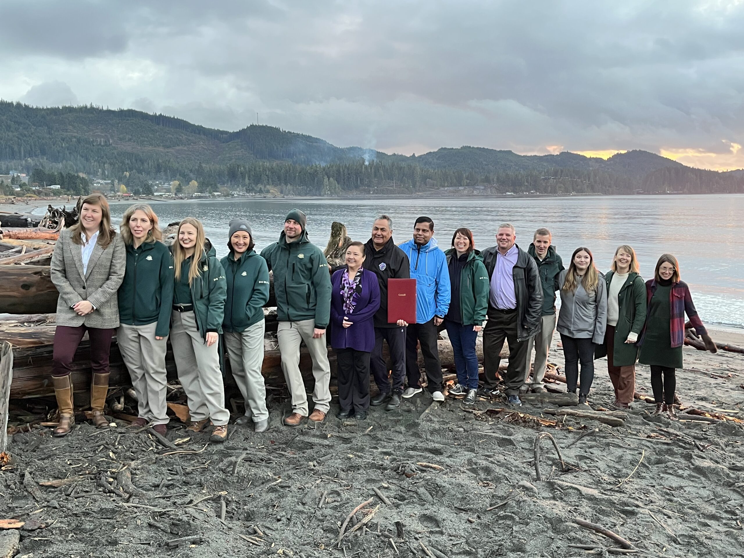 Members of Pacheedaht and DitidahtFirst Nation, CIRNAC, Parks Canada, and other local officials at ?a:?b?e:?s (Middle Beach)