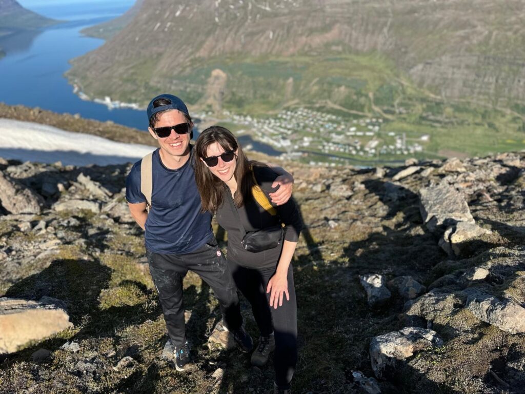 Matt and Hillary Austman hiking on top of a mountain.
